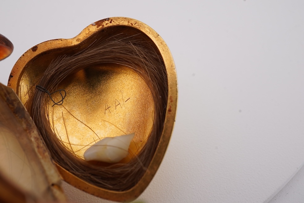 A modern embossed 9ct gold heart shaped locket, 21mm, on a similar 9ct gold rope twist chain, 46cm, together with one other yellow metal heart shaped locket, on a yellow metal chain, gross weight 14.5 grams. Condition -